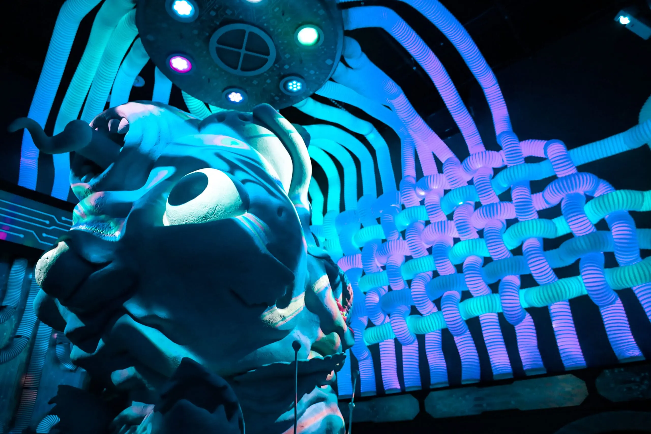 A surreal Otherworld room with intricate sculptural lighting and immersive set design.